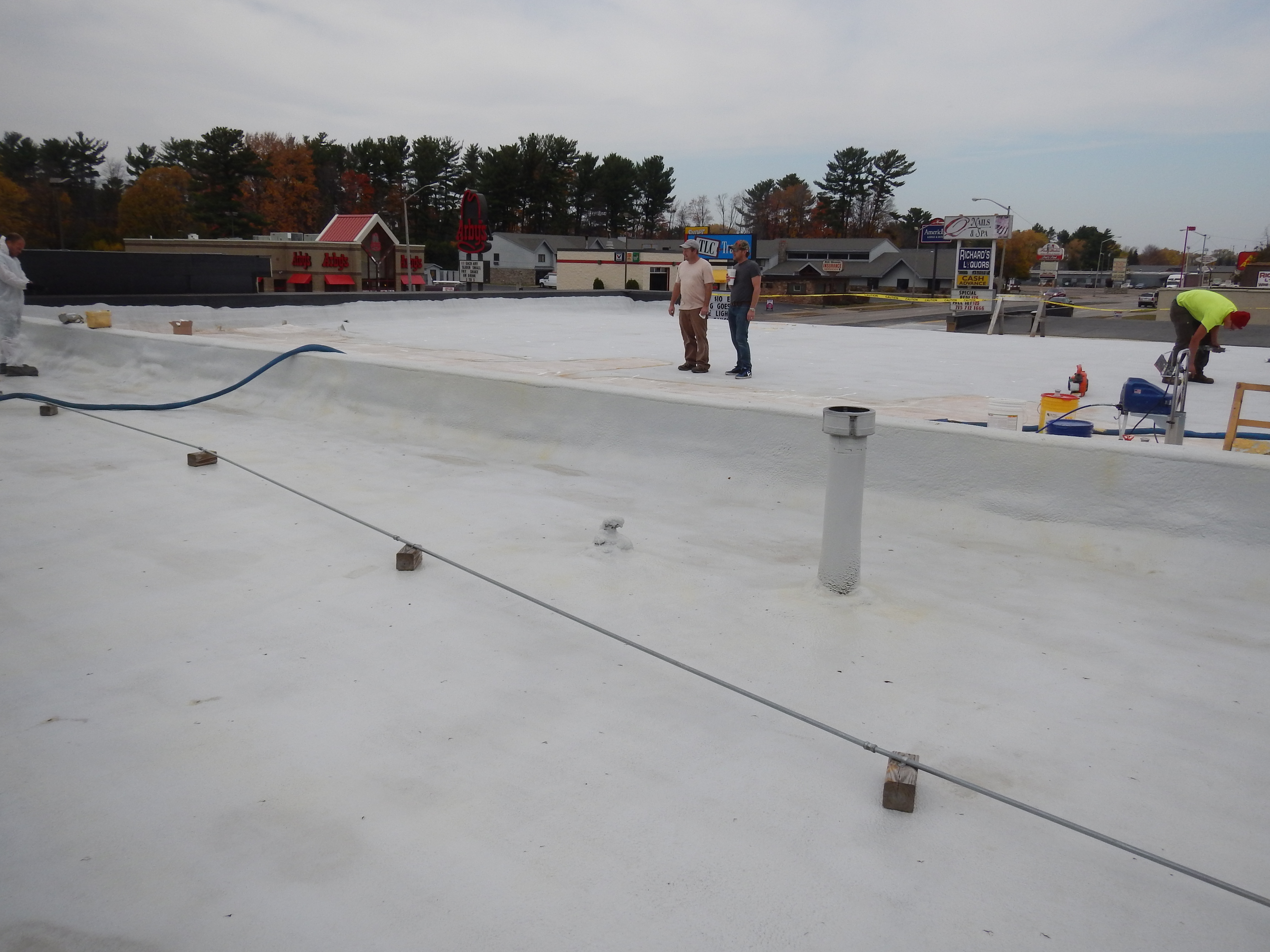 Commercial roof restoration with polyurea coating